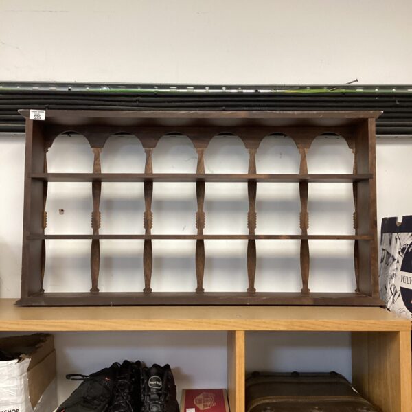 Vintage wooden divided curio shelf for displaying collectibles.