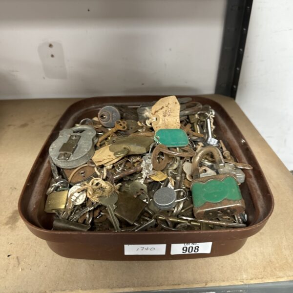 Vintage padlocks and keys in a metal tray, antique lock collection.