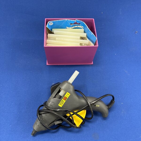 Used Stanley glue gun with glue sticks for DIY projects.