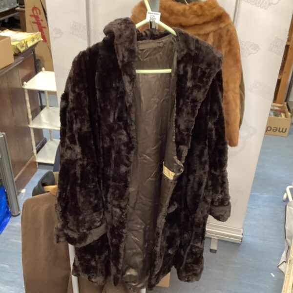 Full view of antique black fur coat, vintage women's fashion.