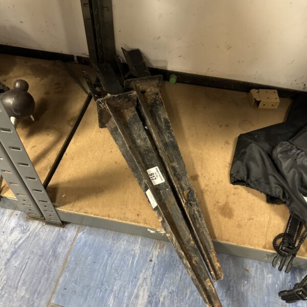 Two metal fence post stakes for garden and landscaping projects.