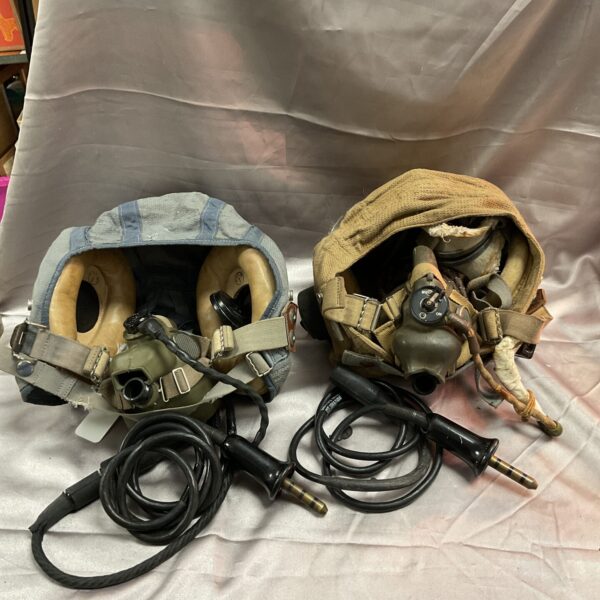 Pair of vintage RAF cloth flying helmets with masks and cables.