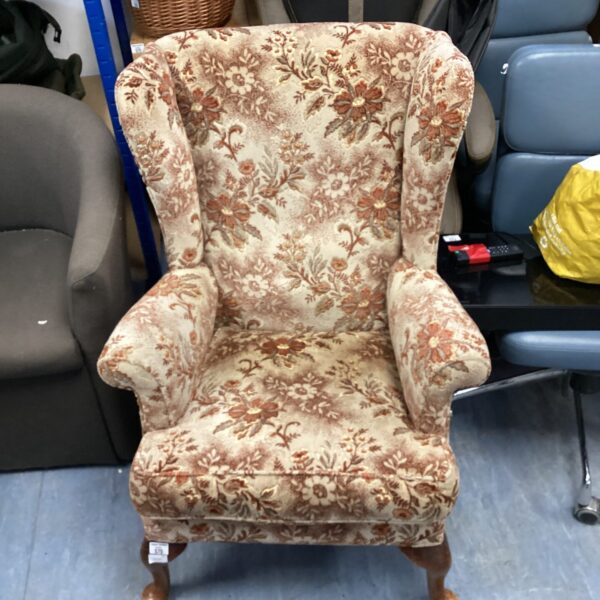 Vintage floral Parker Knowl armchair with patterned upholstery.