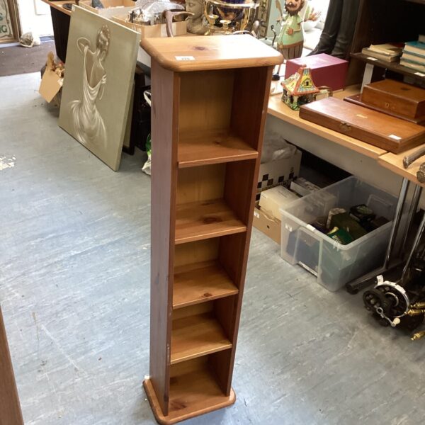 Vintage pine shelving unit with five shelves for display.