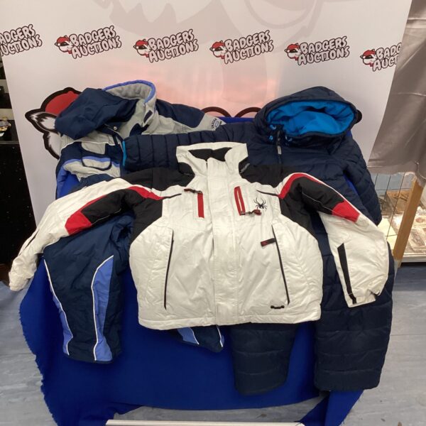 Bundle of three colourful childs ski suits for winter sports.