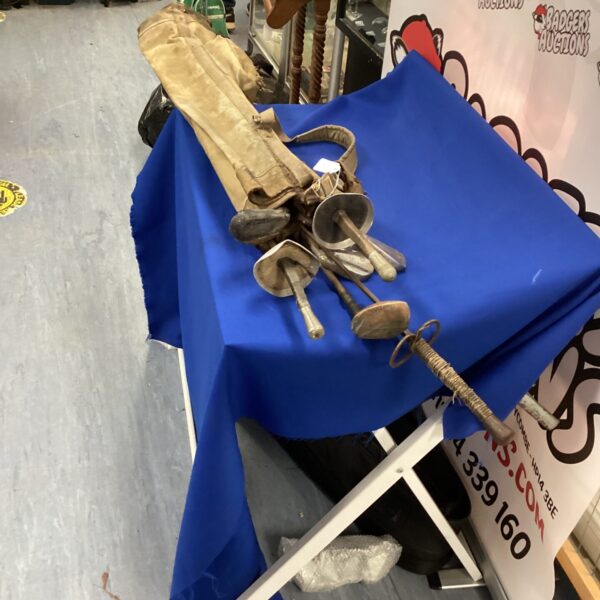 Vintage golf clubs and swords in a mixed lot collection.