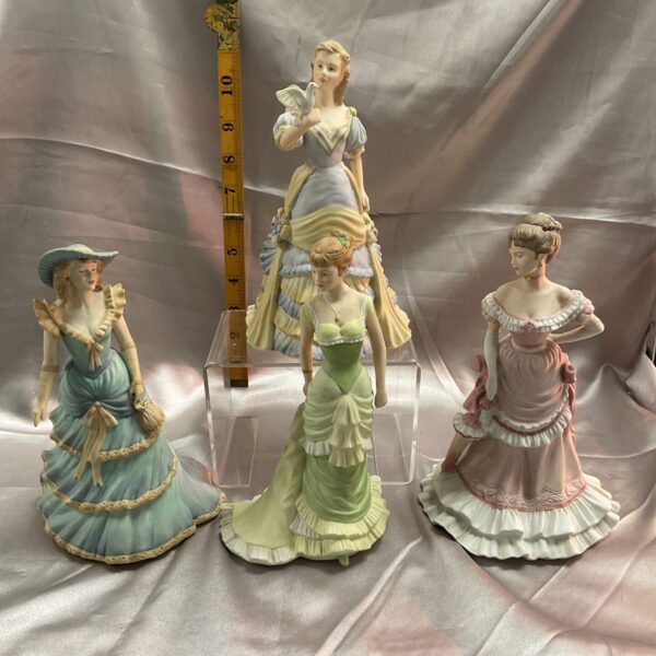 Set of four Coalport Age of Elegance figurines in detailed Regency attire.