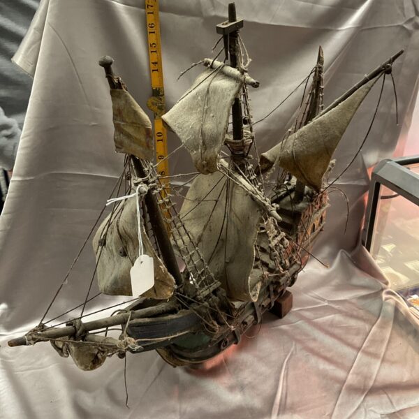 Detailed antique wooden model of a 17th-century galleon ship.