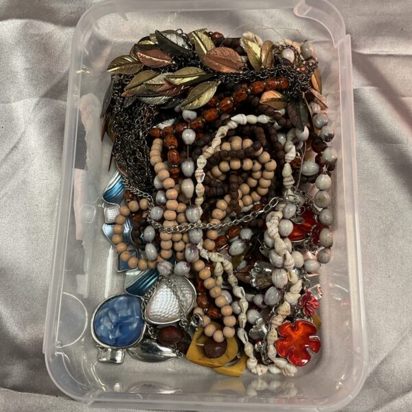 Assorted vintage costume jewellery lot with necklaces and brooches.