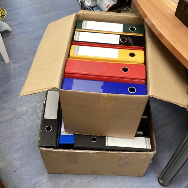 Two boxes of colourful lever arch files for document storage.