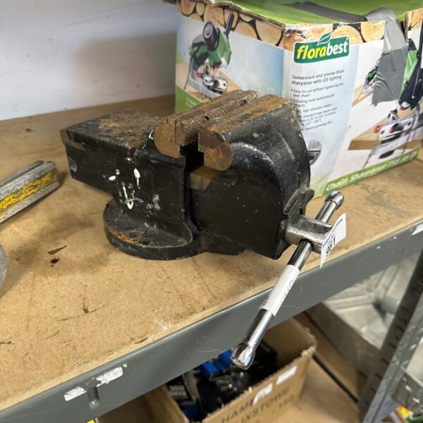 Small metal bench vice for workshop use.