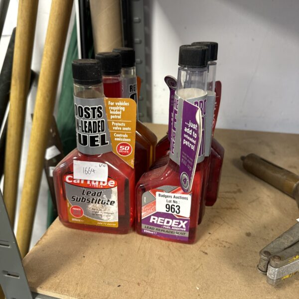 Six bottles of vintage lead replacement fuel additive for classic cars.