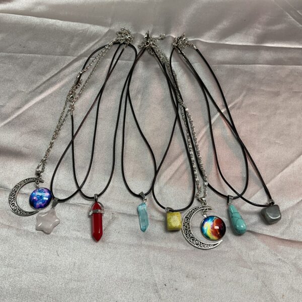 Lot of eight crystal and stone necklaces with varied pendants.