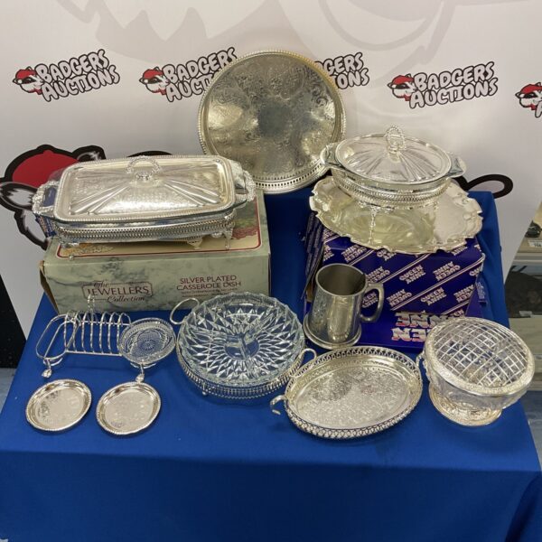 Vintage silverplate tableware collection with casserole dish and trays.