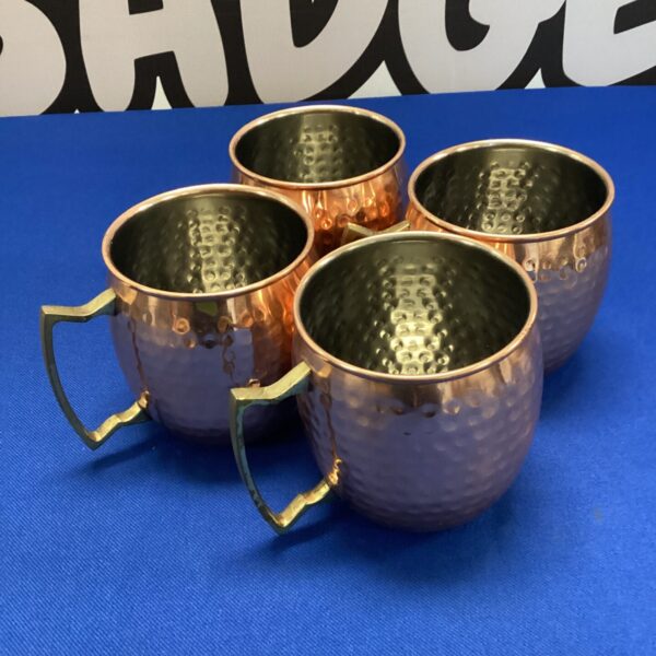 Set of four hammered copper Moscow mule mugs for cocktails.