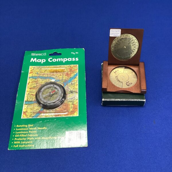 Vintage Stesco map compass with fifty year calendar displayed.