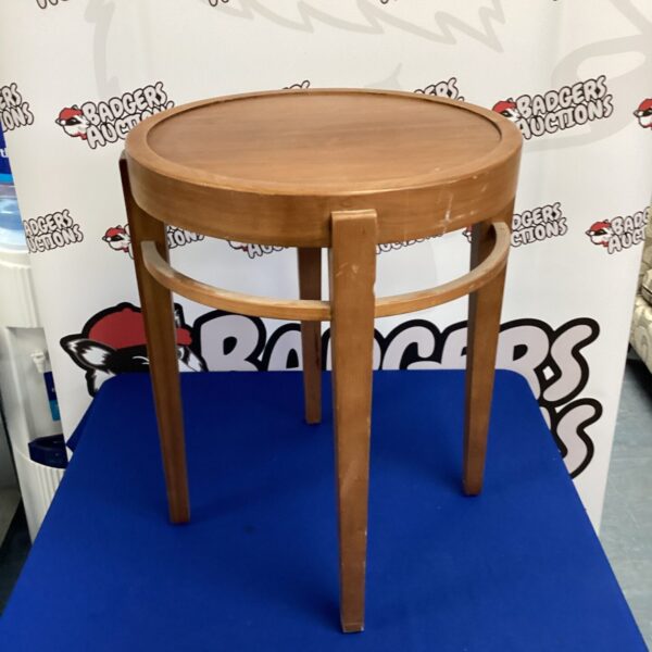 Vintage round magazine table with wooden legs.