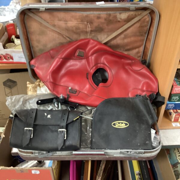 Harley Davidson motorbike parts lot with leather jacket inside.