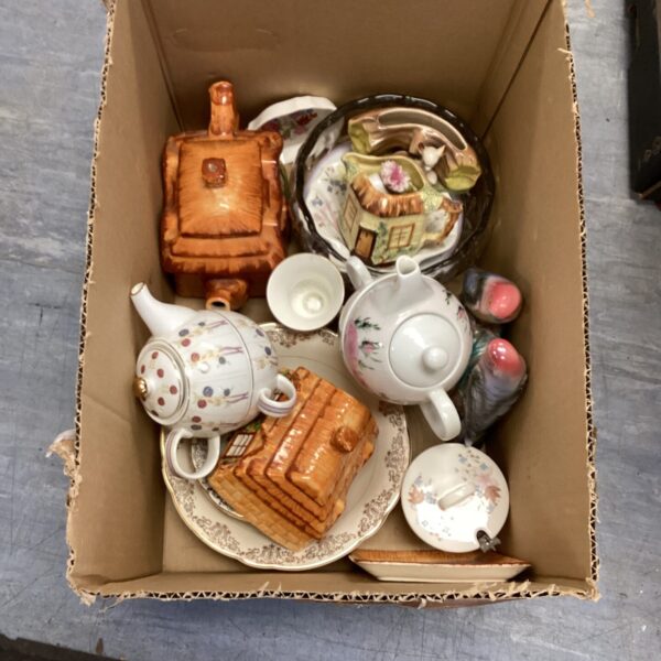 Vintage Staffordshire pottery collection featuring a teapot and figurines.