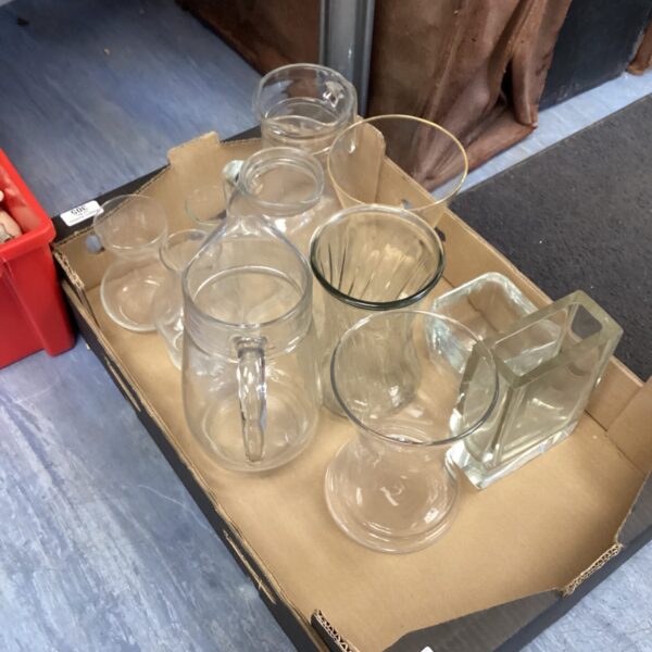 Mixed glassware lot featuring clear glass pitchers and assorted glasses.