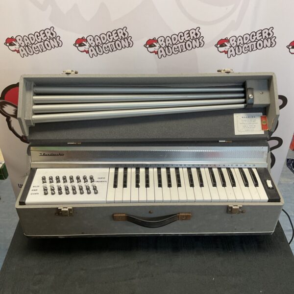 Front view of a vintage J. Busilacchio portable organ keyboard.