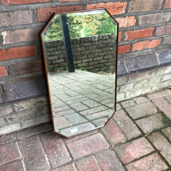 Vintage octagonal bevelled mirror with a clean design.