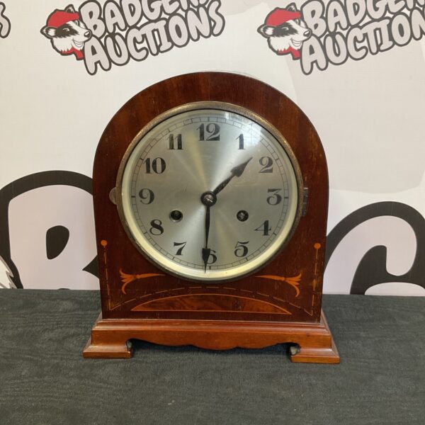 Vintage H&B DRGM mantle clock with inlaid wooden case.