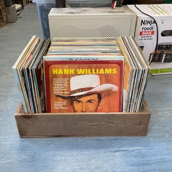 Side view of a crate filled with vintage country vinyl records.