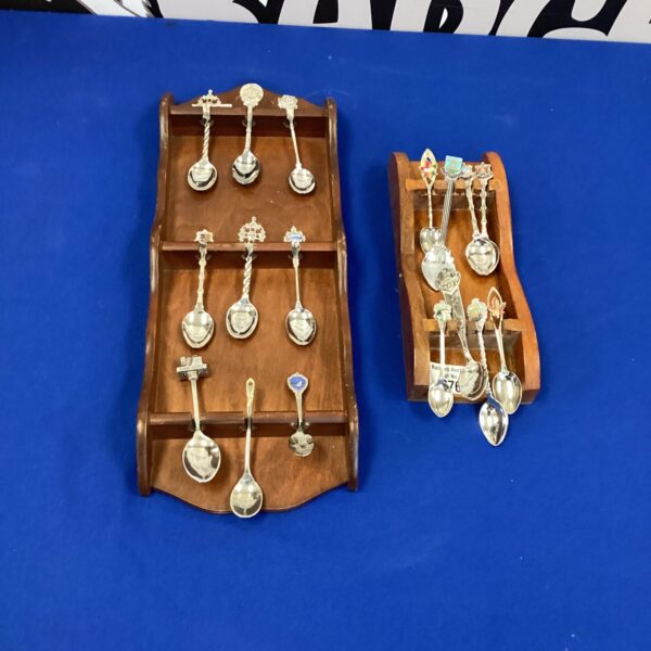 Vintage teaspoon display racks with silver plated spoons.