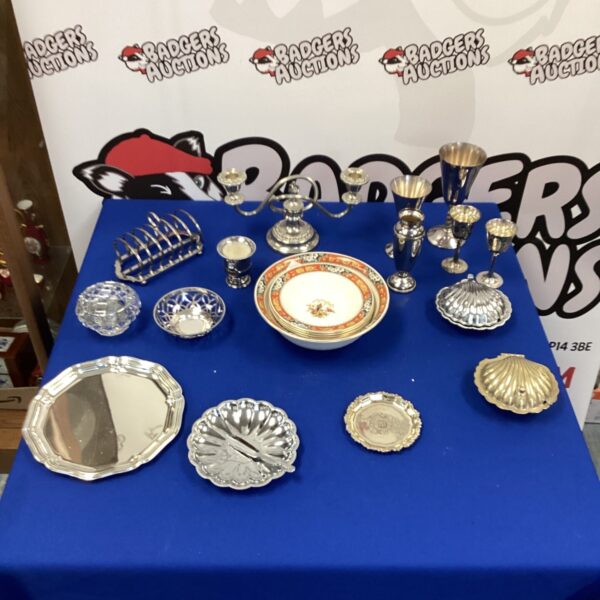 Vintage silverplate tableware and Meakin bowls on display.