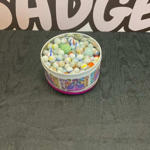 Colourful assortment of vintage glass marbles in a tin.
