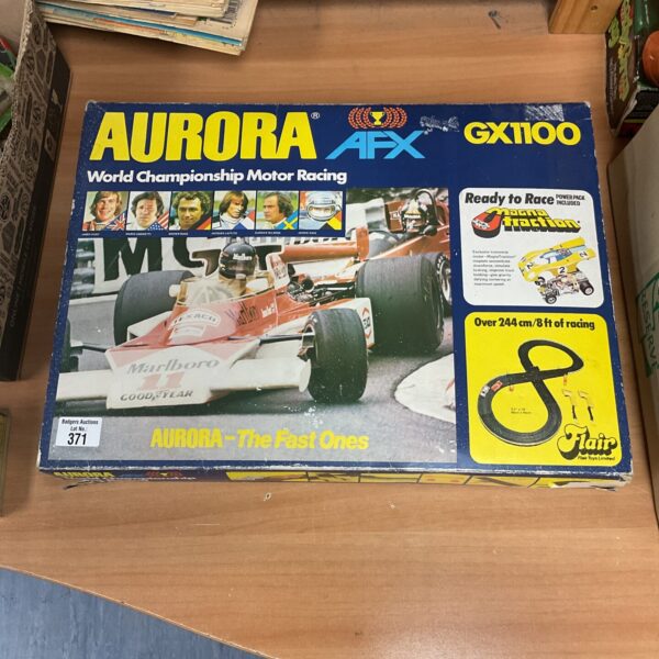 Vintage Aurora AFX racetrack set with track sections visible.