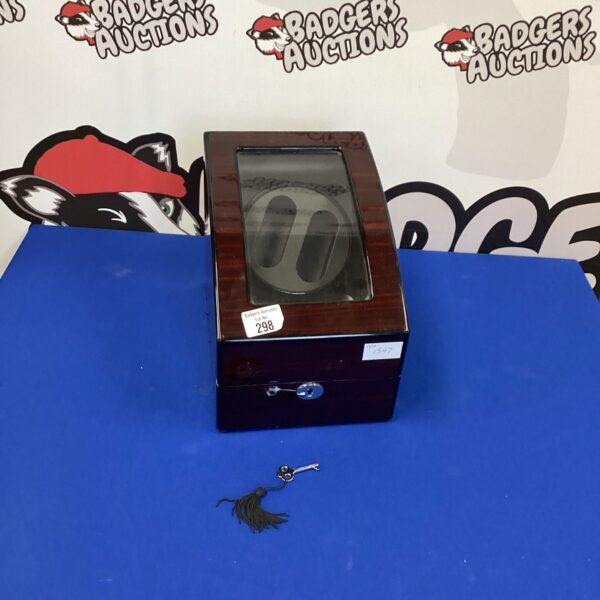 Wooden watch winder case with glass top and key lock.