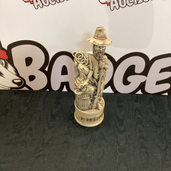 Vintage porcelain moonshine bottle figurine, detailed ceramic sculpture.