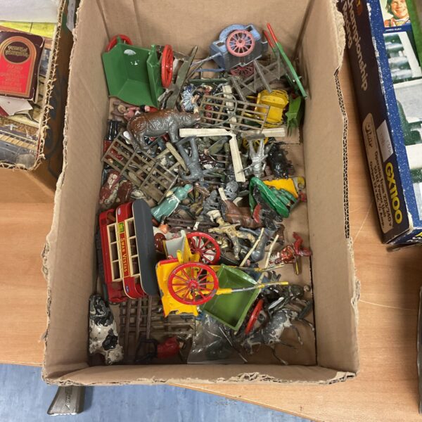 Vintage lead figure collection featuring soldiers and animals.