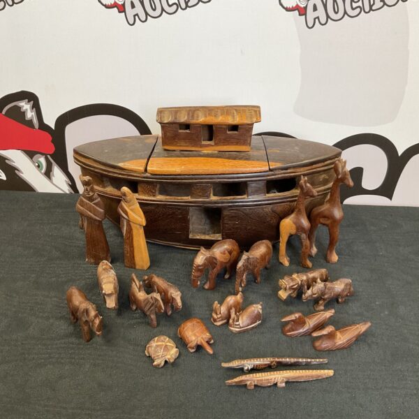 Vintage ebony Noah’s Ark with intricately carved animal figures.
