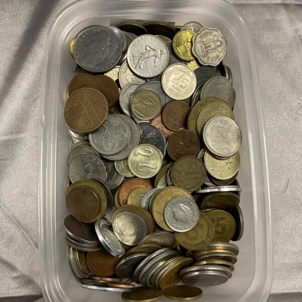 Mixed coin lot in a clear tub, diverse world coins.