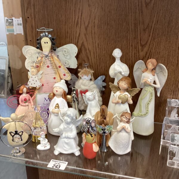 A collection of vintage porcelain angel figurines on display.