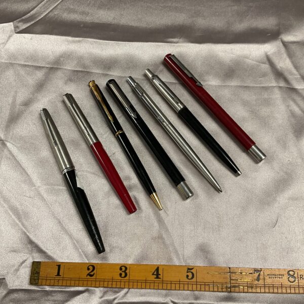 Vintage Parker pen collection displayed on a neutral background.