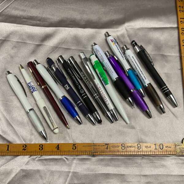 Assorted collection of branded promotional pens for collectors.