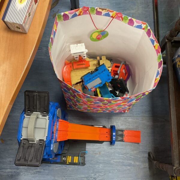 Hot Wheels Mega Garage playset with cars and accessories displayed.