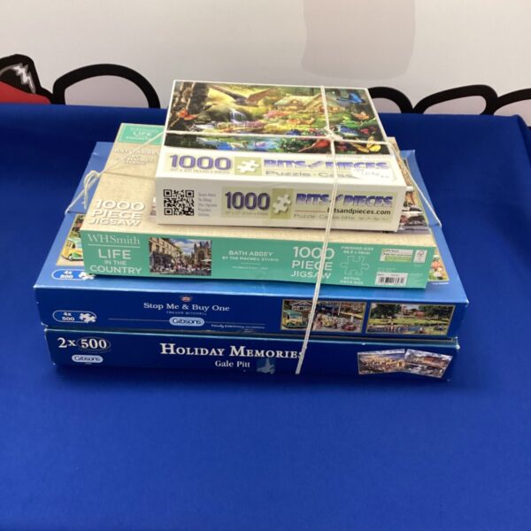 Lot of four jigsaw puzzles including Gibsons brand.