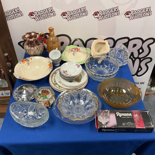 Mixed lot of vintage china and glassware on display.