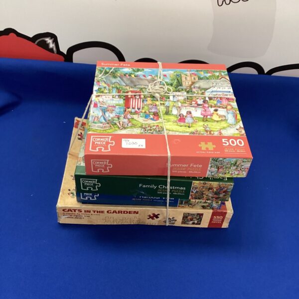 Vintage jigsaw puzzle lot with colourful illustrations.