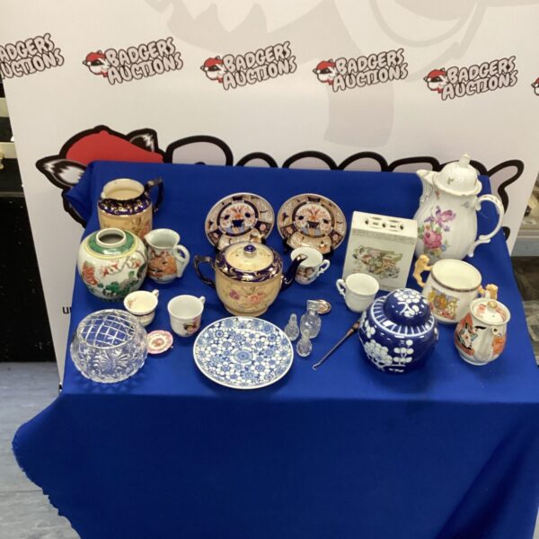 Mixed ceramic collection with a prominent ginger jar and decorative china.