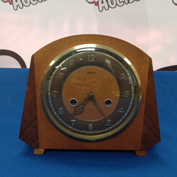 Vintage Smiths mantle clock with wooden case and clear dial.