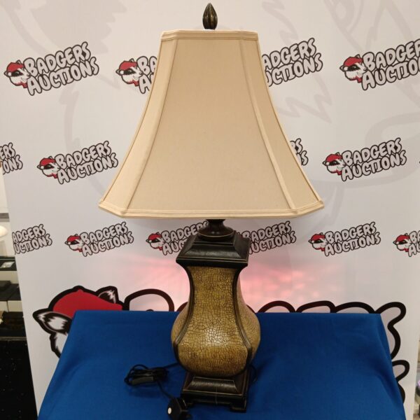 Large oriental table lamp with ceramic base and cream shade.