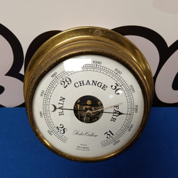 Antique brass Foster Caleer barometer displaying weather conditions.