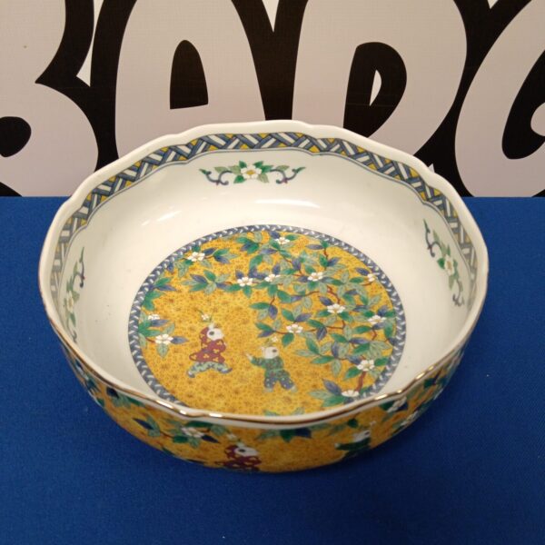 Vintage Japanese fruit bowl with yellow background and floral design.