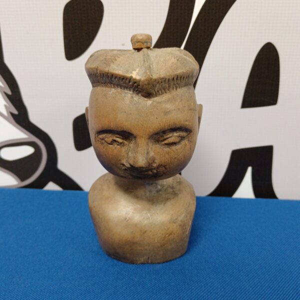 Front view of a hand-carved wooden boy bust sculpture.